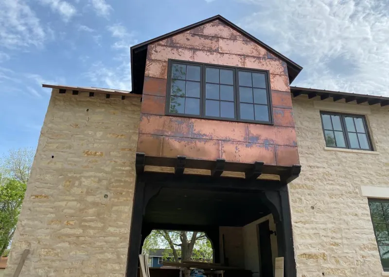 Copper metal panel facade on a stone building for Roof Repair in Villa Hills